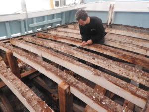 Mylor's shipwright working on 12m fishing boat, Lamorna's deck