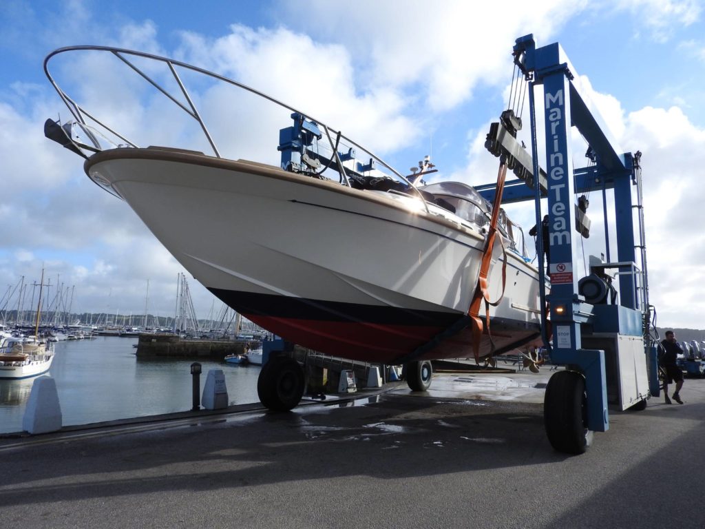 Freebird in the hoist ready for launch at Mylor Yacht Harbour