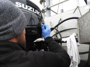 Mylor Marine Engineer installing Suzuki DF30 Outboard engine